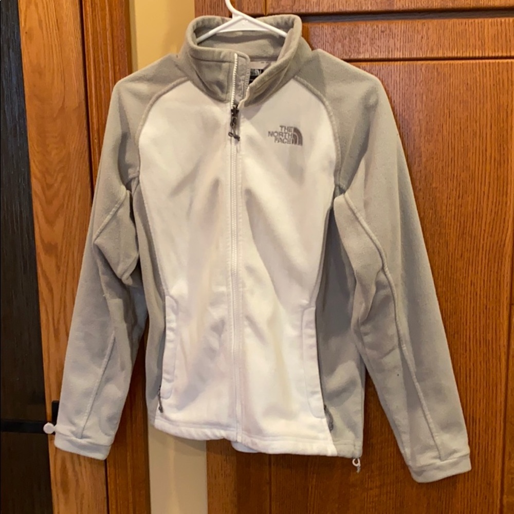 White and gray woman’s Northface jacket